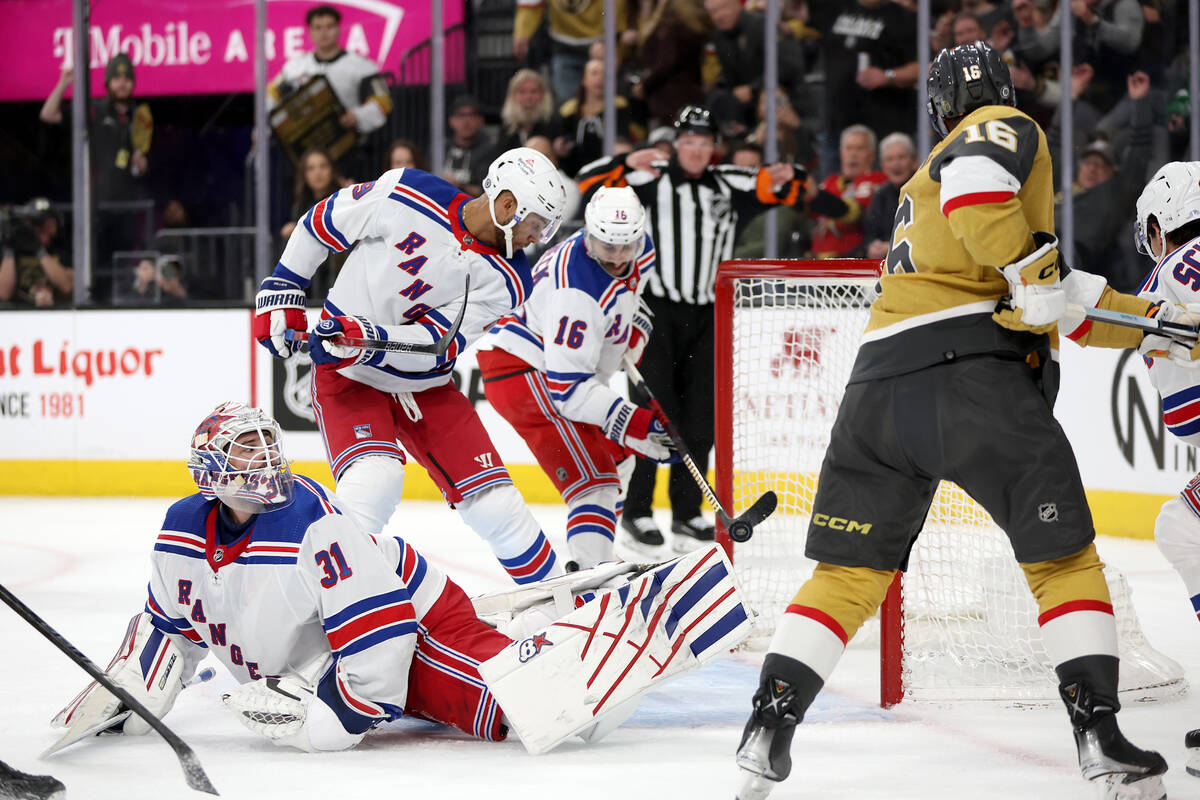 Rangers goaltender Igor Shesterkin (31) looks for the puck as center Vincent Trocheck (16) tips ...