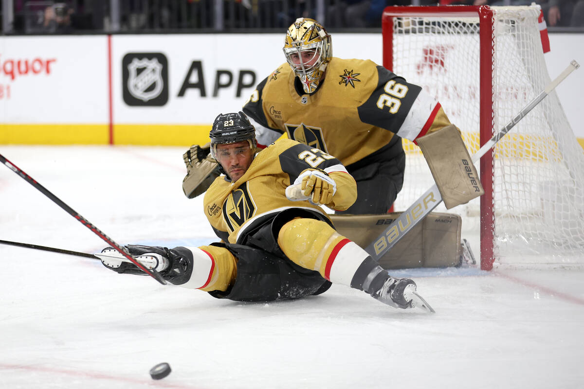 Golden Knights defenseman Alec Martinez (23) slides in front of the goal while the Rangers shoo ...