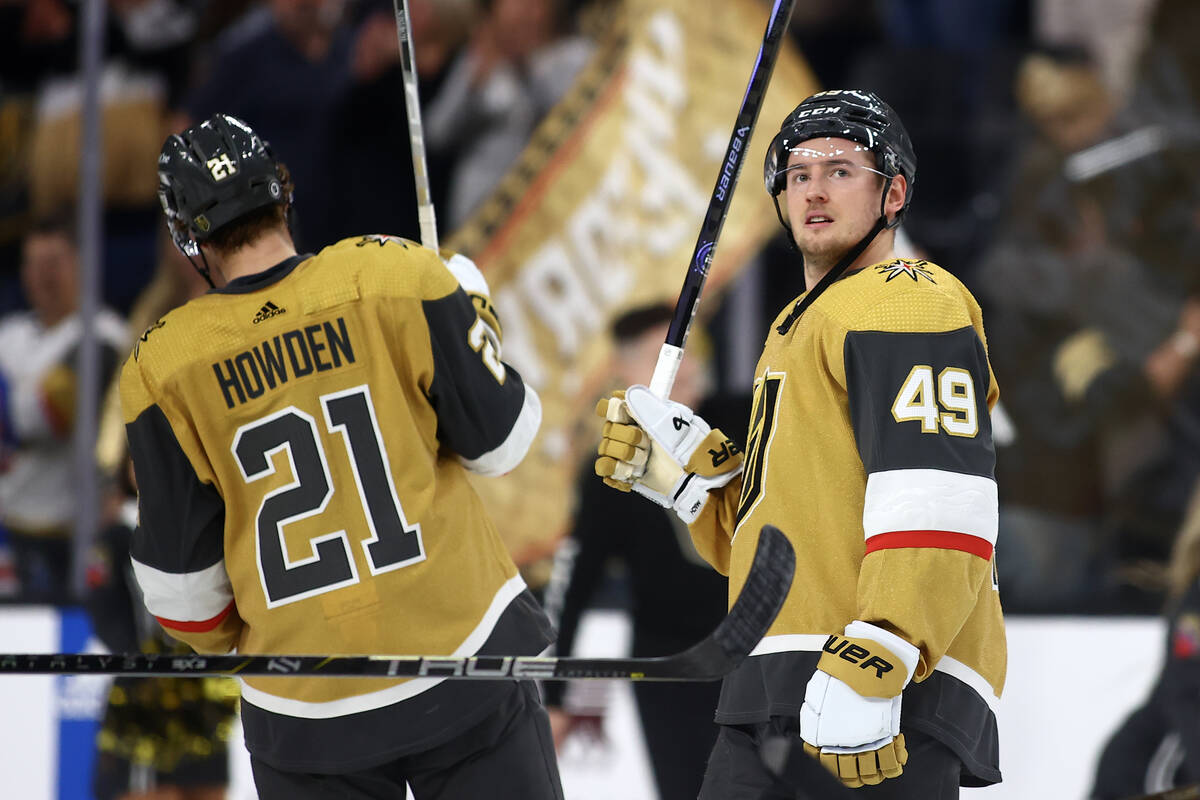 Golden Knights center Ivan Barbashev (49) and center Brett Howden (21) celebrate after winning ...