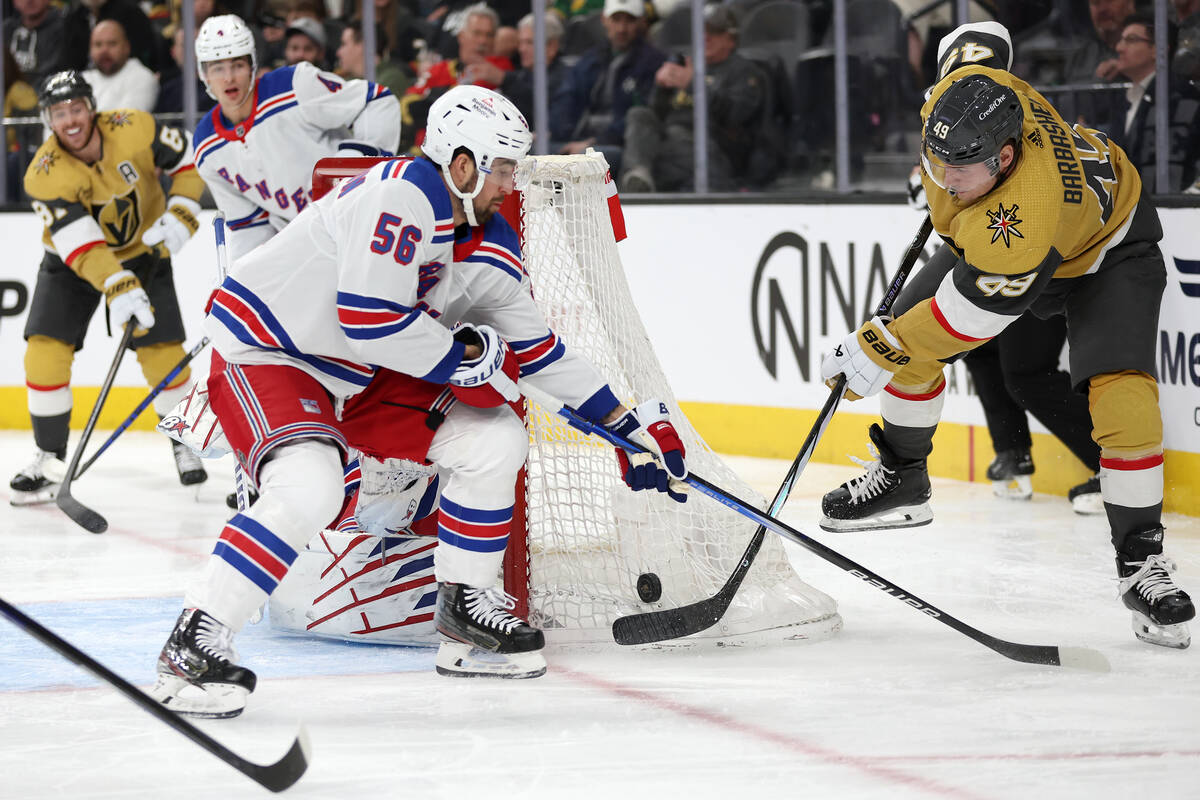 Golden Knights center Ivan Barbashev (49) attempts a goal while Rangers defenseman Erik Gustafs ...