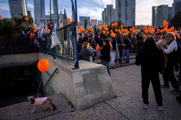 Demonstrators hold orange balloons at a rally in solidarity with Kfir Bibas, an Israeli boy who ...