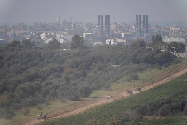 Israeli forces move near the Israeli-Gaza border, in southern Israel, Thursday, Jan. 18, 2024. ...