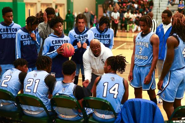 Canyon Springs head coach Freddie Banks speaks to his team during a timeout in the second half ...