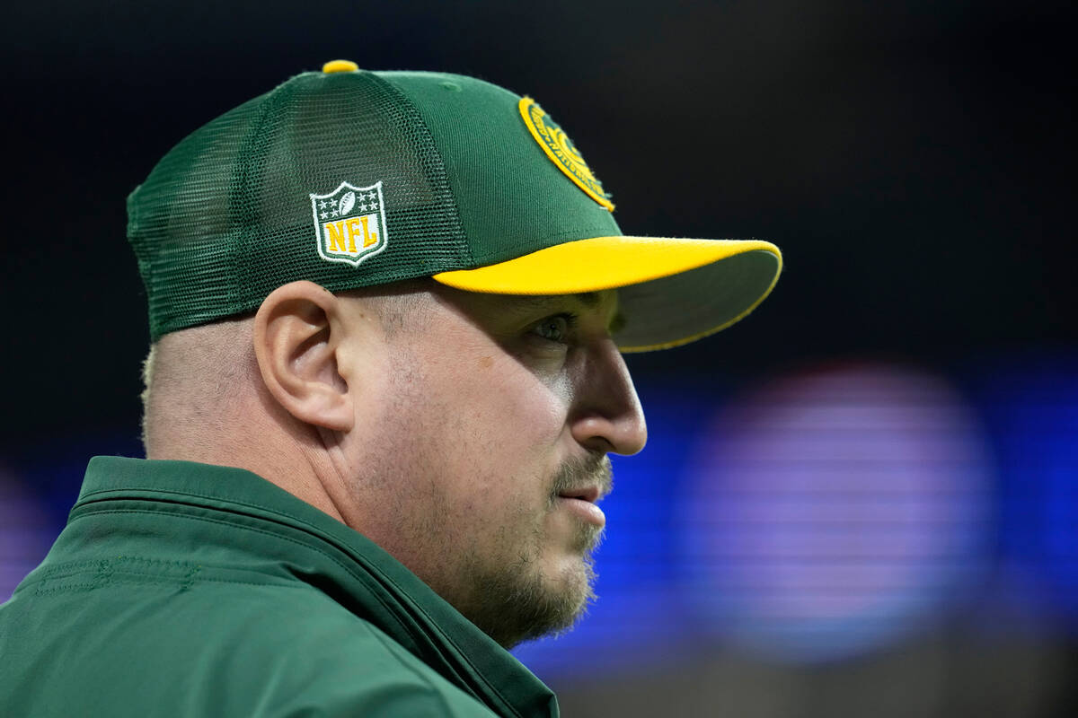 Green Bay Packers offensive coordinator Adam Stenavich stands on the field before an NFL footba ...