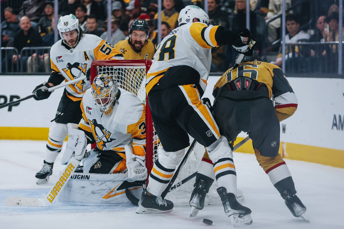 Golden Knights left wing Pavel Dorofeyev (16) tries to get the puck back near the net during a ...