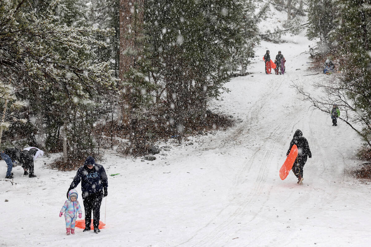 Ire-Lynn Rettinger, 2, plays with her brother Aiden, 16, off the side of the road in Kyle Canyo ...