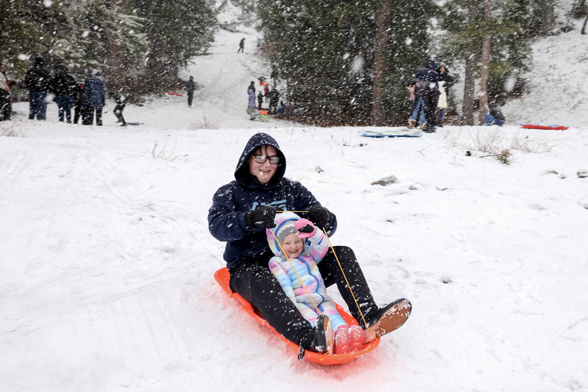 Ire-Lynn Rettinger, 2, plays with her brother Aiden, 16, off the side of the road in Kyle Canyo ...