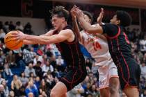 Coronado’s JJ Buchanan (10) rebounds the ball during a basketball game between Coronado ...