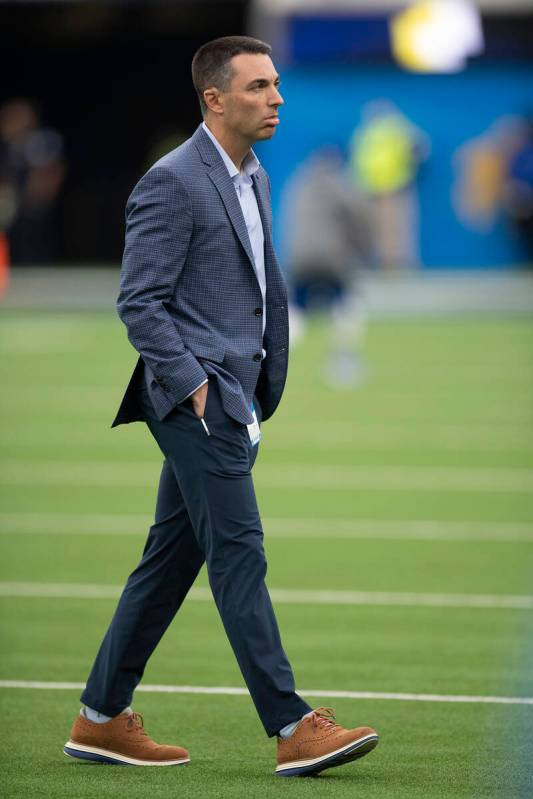 Los Angeles Chargers general manager Tom Telesco talks on the field before an NFL football game ...