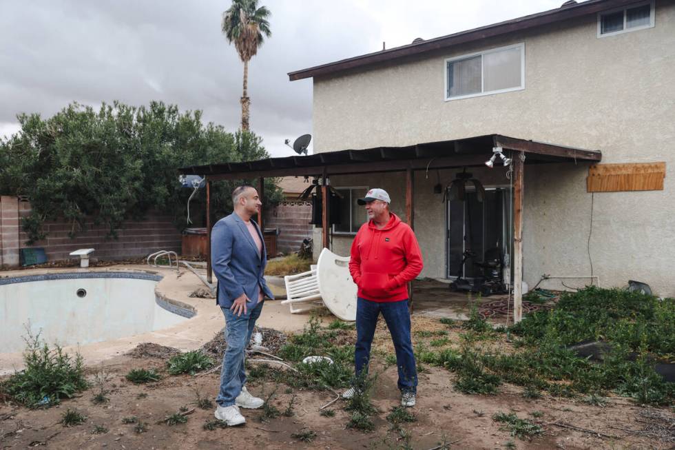 Adam Fenn of Compass Realty & Management, left, listens to Patrick King at a house in Las Vegas ...