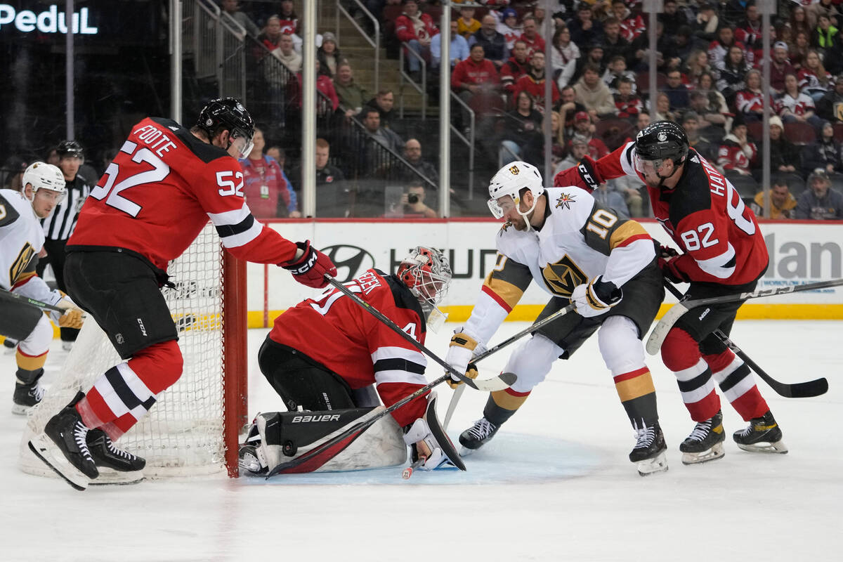 New Jersey Devils goaltender Vitek Vanecek (41), defenseman Santeri Hatakka (82) and defenseman ...