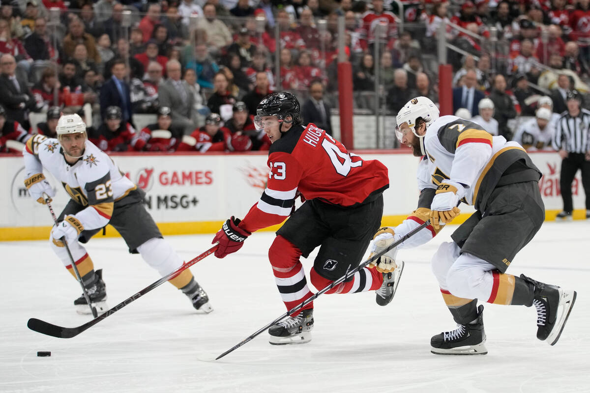 New Jersey Devils defenseman Luke Hughes (43) skates against Vegas Golden Knights defenseman Al ...