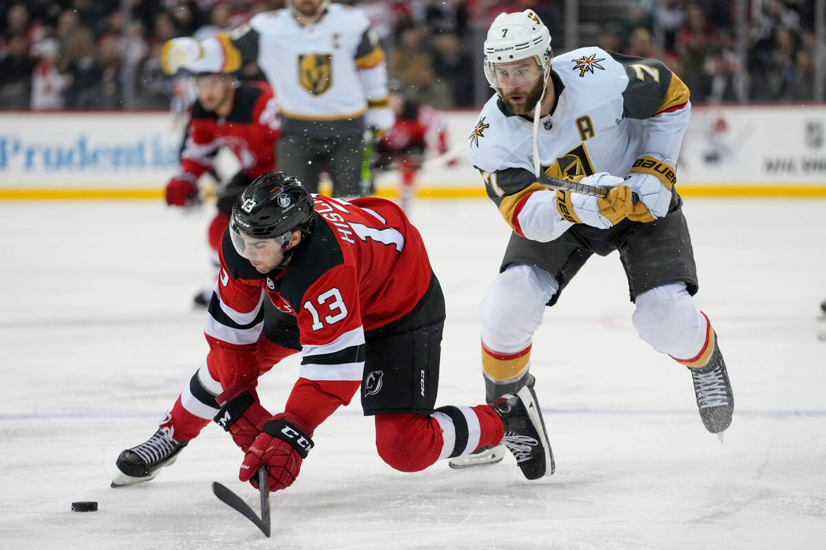 New Jersey Devils center Nico Hischier (13) skates against Vegas Golden Knights defenseman Alex ...