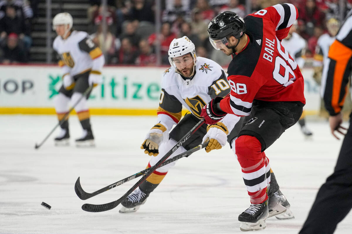 Vegas Golden Knights center Nicolas Roy (10) skates against New Jersey Devils defenseman Kevin ...