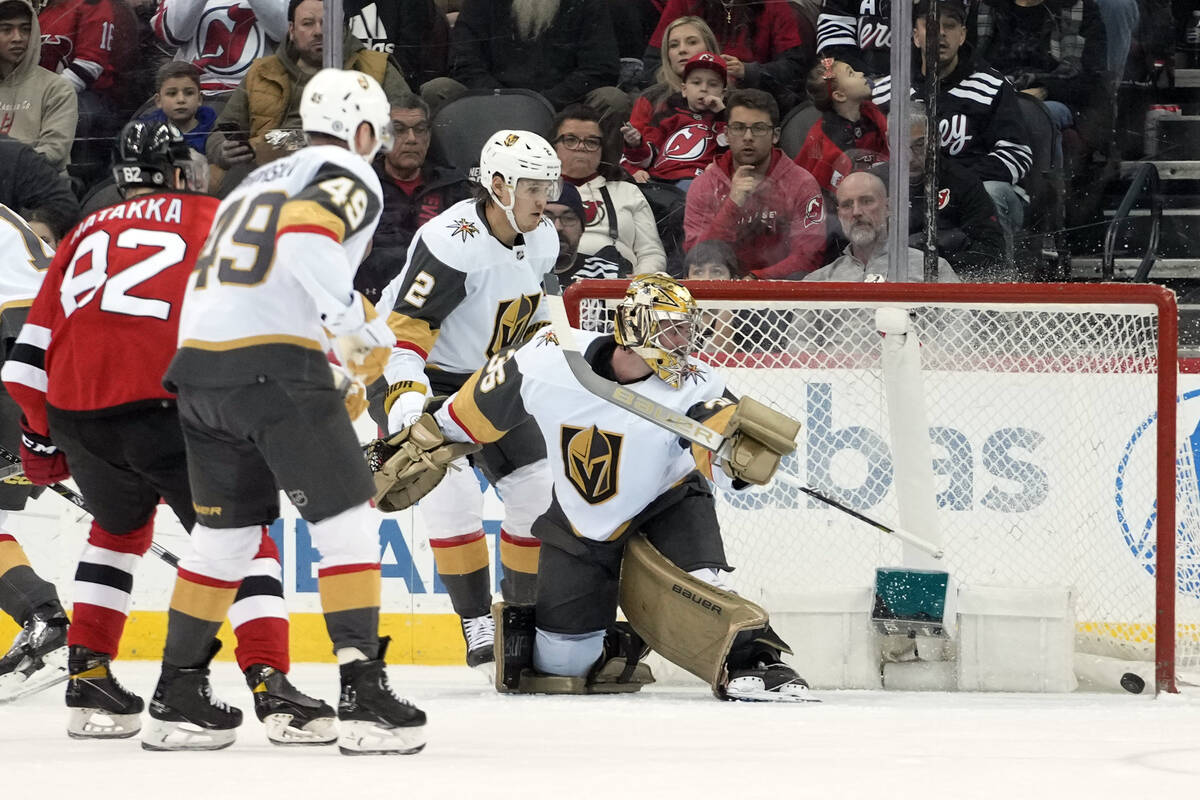 Vegas Golden Knights goaltender Logan Thompson (36) watches as a shot by New Jersey Devils cent ...