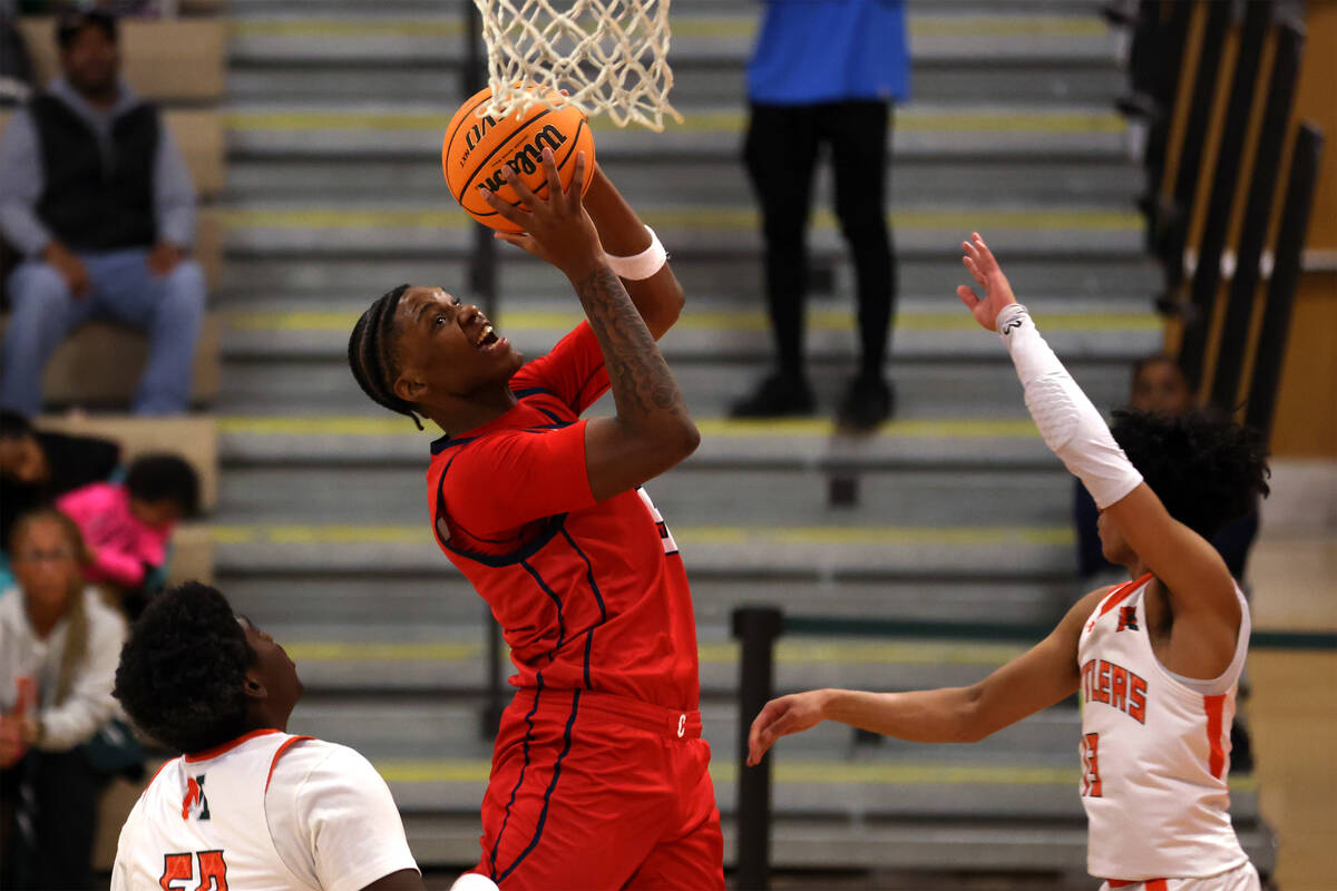 Coronado's Lantz Stephenson (5) shoots against Mojave forward Avondre Smith (50) and guard Nath ...