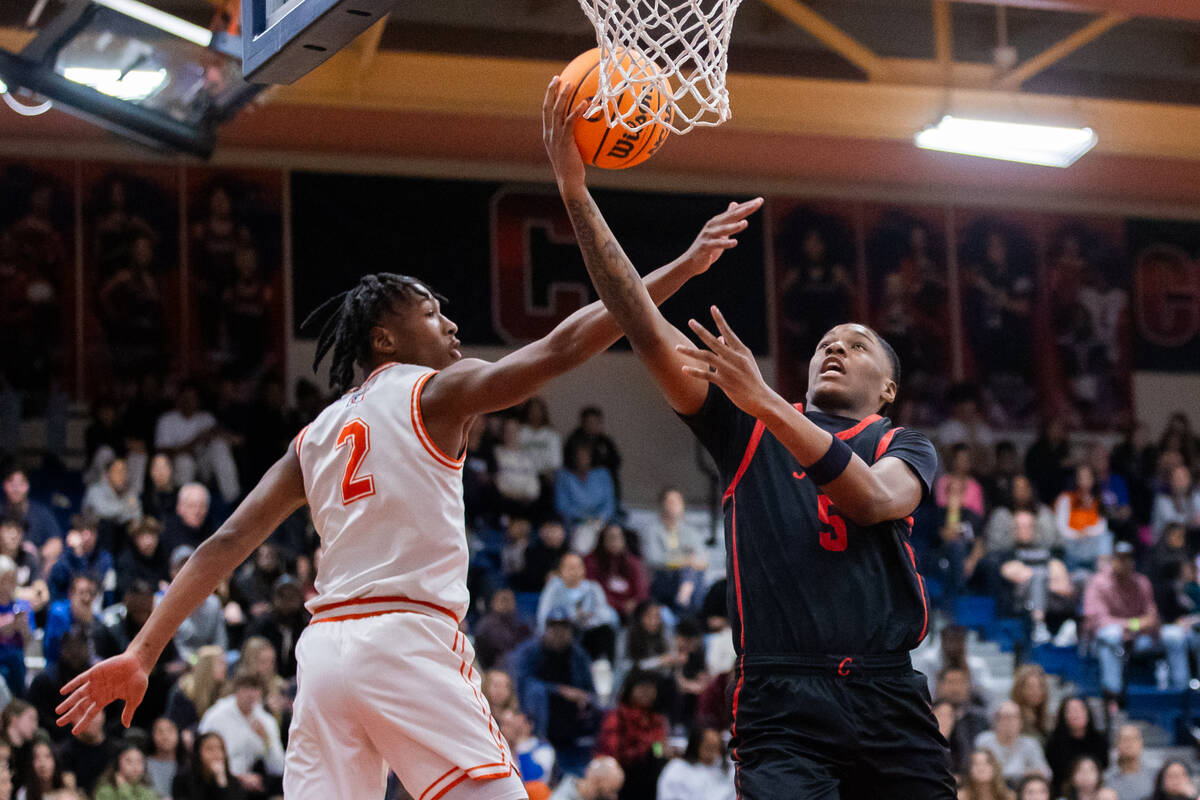 Coronado’s Lantz Stephenson (5) takes a shot around Bishop Gorman’s Jett Washingt ...