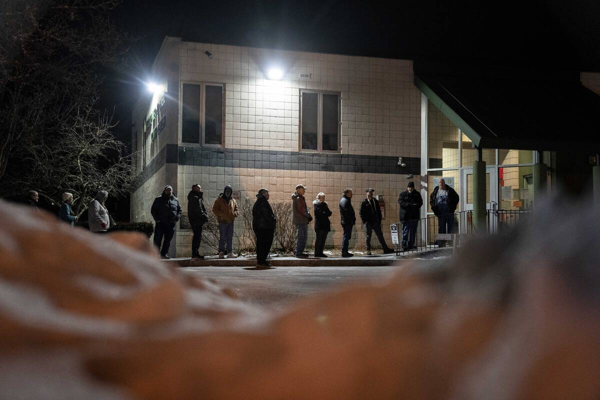 Voters line up for the polls to open to cast their ballots in the New Hampshire Republican pres ...