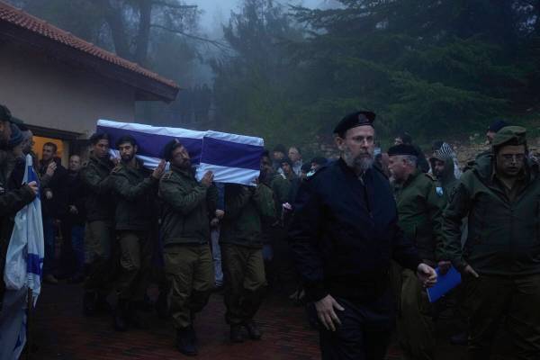 Israeli soldiers carry the flag-draped casket of reservist Ariel Mordechay Wollfstal during his ...
