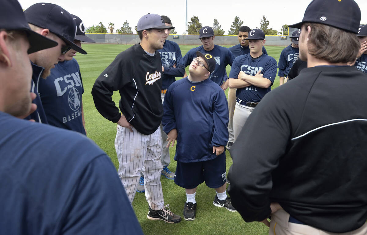 College of Southern Nevada baseball team manager Matty Cutler, center, listens as assistant coa ...