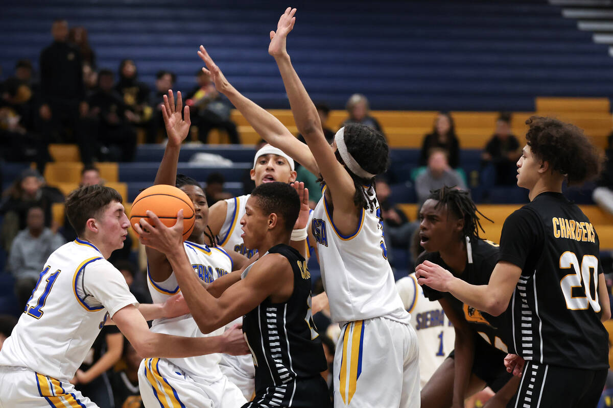 Clark guard De'Shaun Tolever (21) snags a rebound while surrounded by Sierra Vista during the s ...