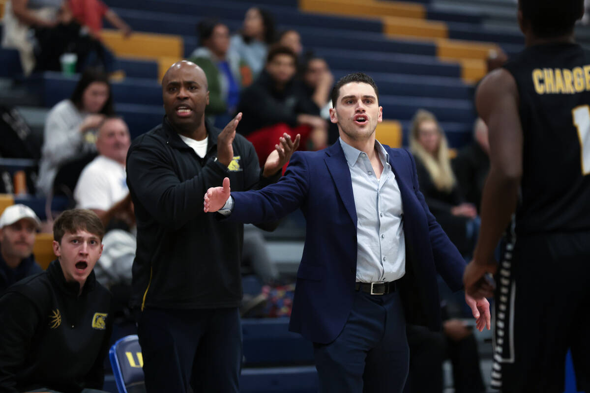 Clark head coach Brent Rothman brings his team in for a time out during the first half of a hig ...