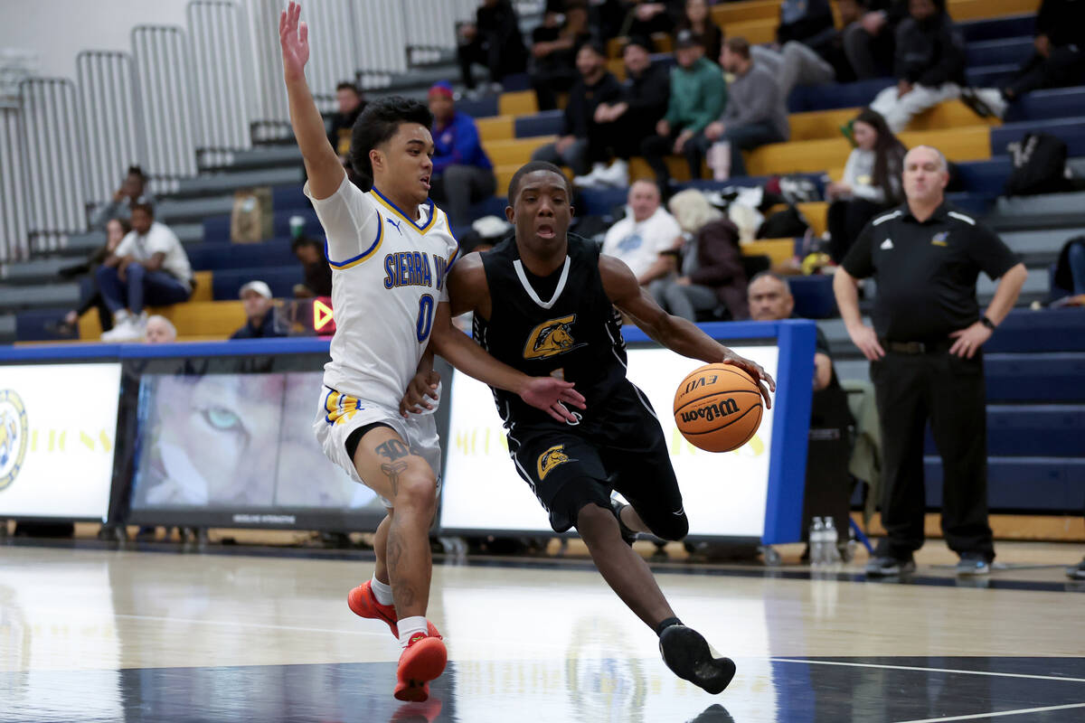 Clark guard Brenden Banks-Speed (1) drives toward the hoop against Sierra Vista guard Ej Dacuma ...