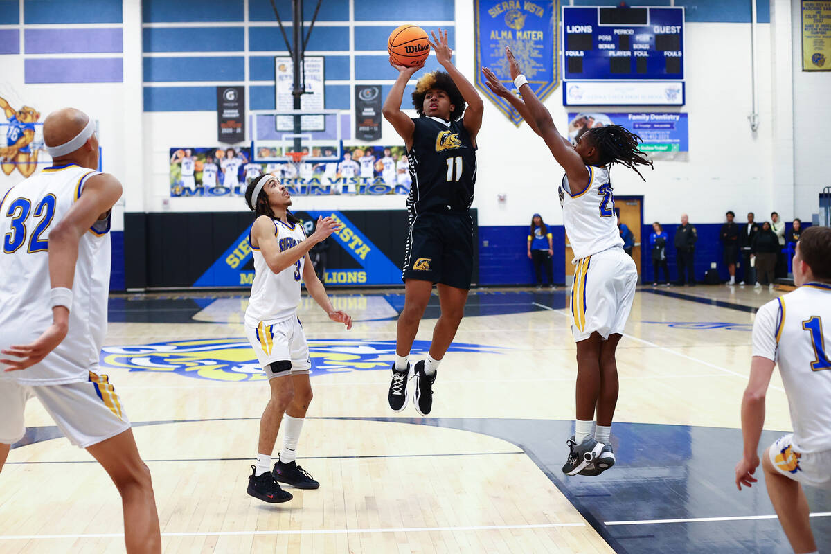 Clark guard Elijah Coleman (11) shoots against Sierra Vista guard Khamari Taylor (3) and forwar ...