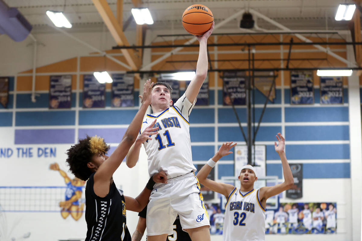 Sierra Vista forward Ethan Nelson (11) shoots against Clark guard Elijah Coleman, left, during ...