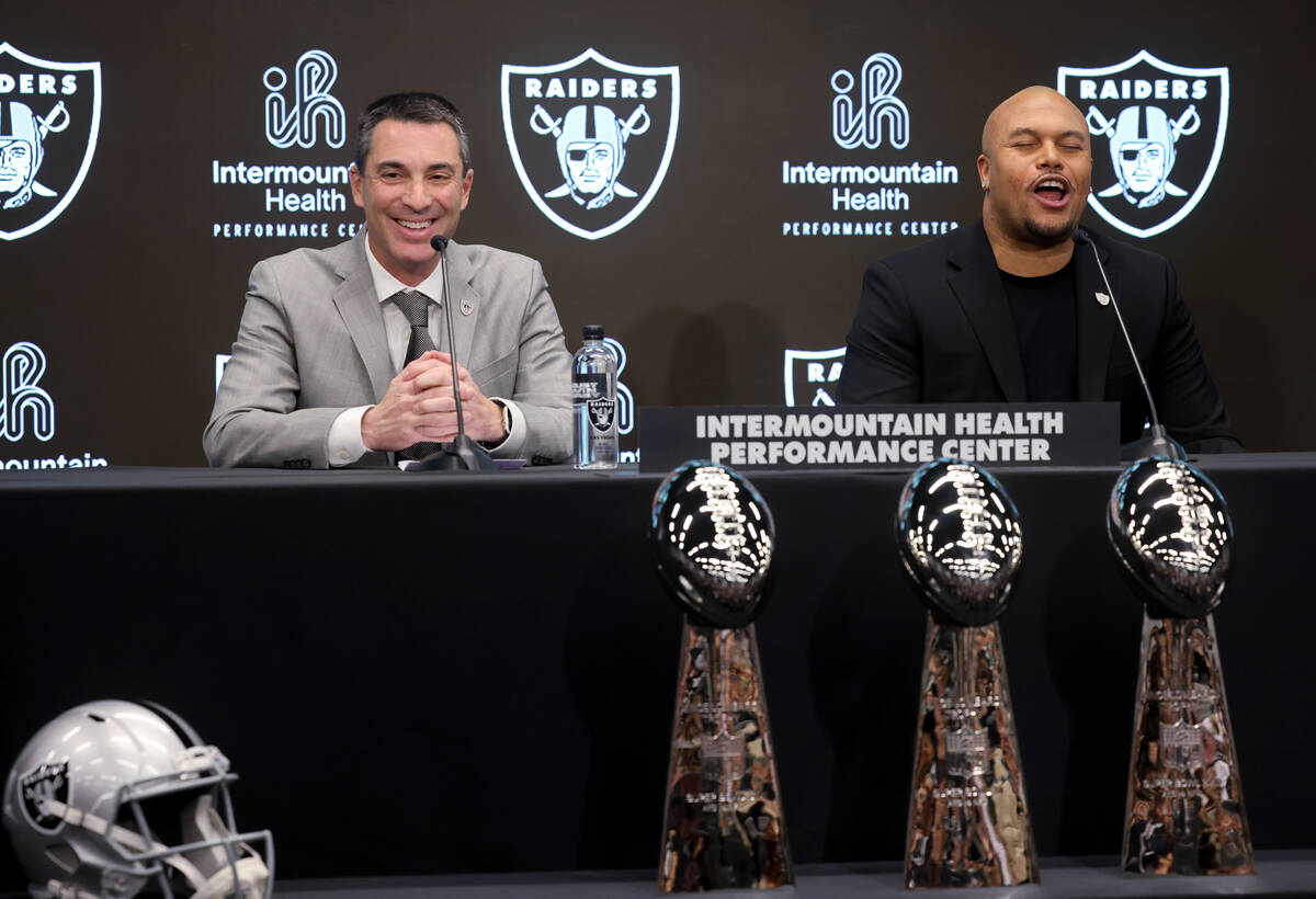 Raiders coach Antonio Pierce, right, chants, “Raiders!” as general manager Tom Te ...