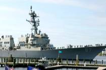 File - The USS Mason, an Arleigh Burke-class destroyer, passes a dock in Norfolk, Va., April 8, ...