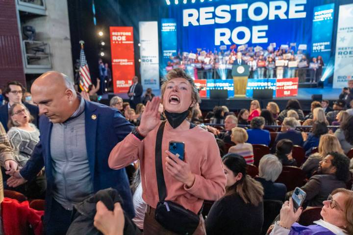 A protester who interrupted President Joe Biden is removed at an event on the campus of George ...