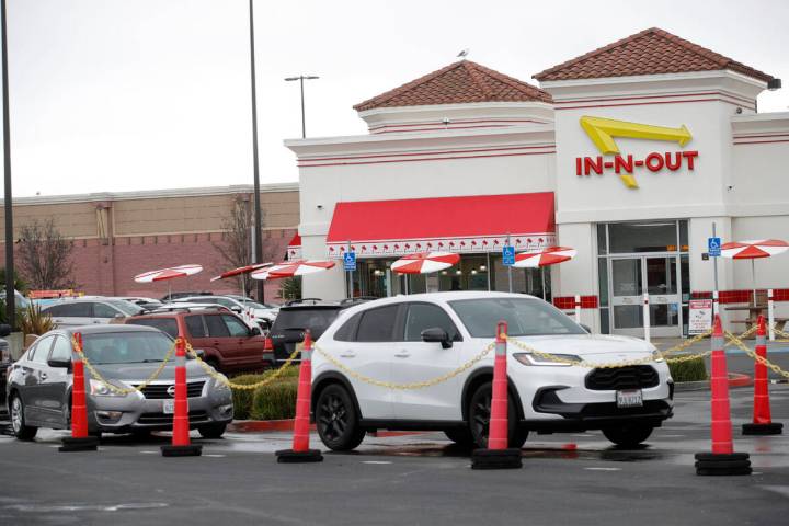 Customers line up at the In-N-Out drive-thru off Hegenberger Road in Oakland, Calif., on Monday ...