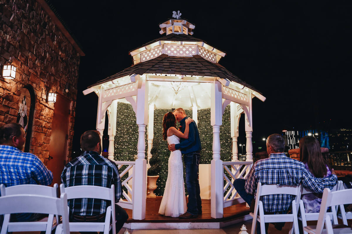 Kendra Smith, left, kisses Kent Hagerman during their wedding ceremony at Vegas Weddings on Thu ...