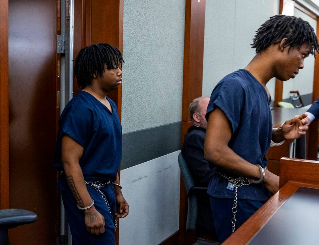 Defendants Gianna Robinson, left, and Dontral Beaver enter the courtroom in the Rancho High bea ...
