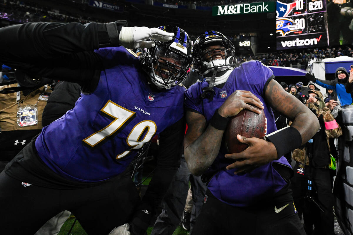 Baltimore Ravens offensive tackle Ronnie Stanley (79) and quarterback Lamar Jackson pose for a ...