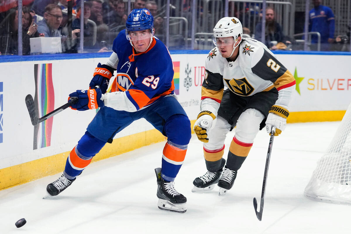 Vegas Golden Knights' Zach Whitecloud (2) defends against New York Islanders' Brock Nelson (29) ...