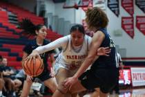 Liberty's Daisha Peavy (12) drives around Spring Valley's Jada Green (23) during the first half ...