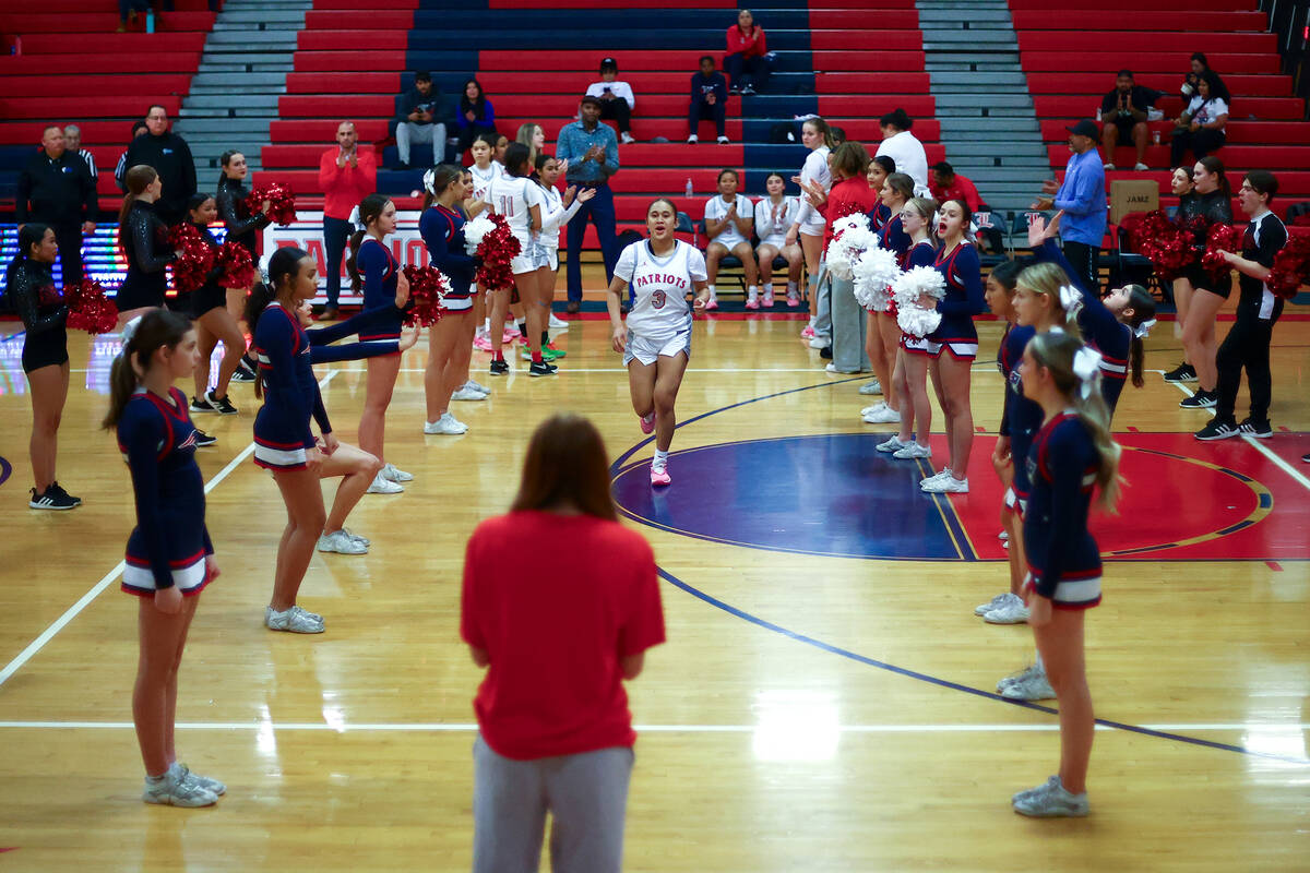 Liberty's Alofa Eteuini (3) is announced in the starting lineup before a high school basketball ...