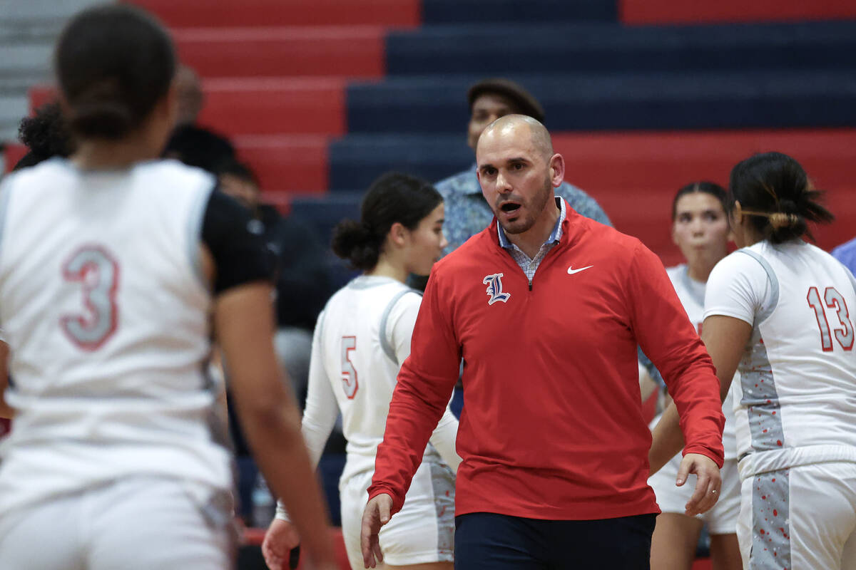 Liberty's head coach Billy Hemberger brings his team in for a timeout during the second half of ...