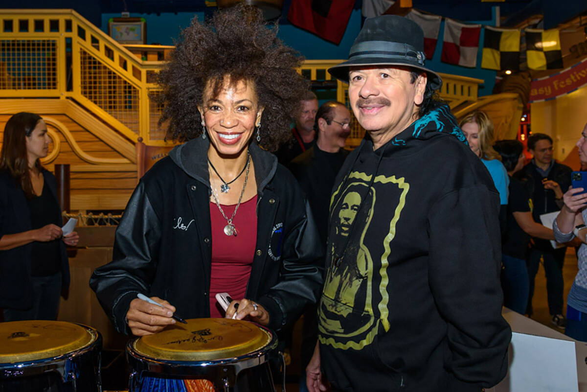 Carlos Santana and Cindy Blackman Santana, shown signing a bongo drum, appear at a Discovery Ch ...