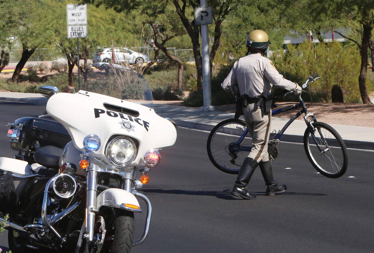 A Metropolitan police officer removes a bicycle from an a crash scene in October 2014 at Alta D ...