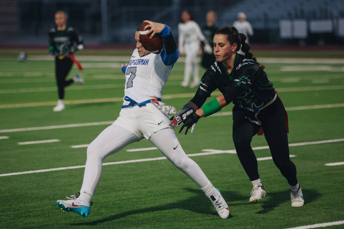 Bishop Gorman quarterback Avery Reed (7) makes a run with the ball as she tries to escape havin ...