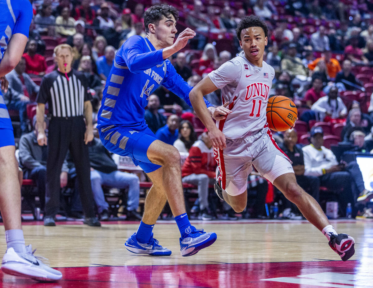 UNLV guard Dedan Thomas Jr. (11) looks to drive the lane against Air Force Falcons forward Beau ...