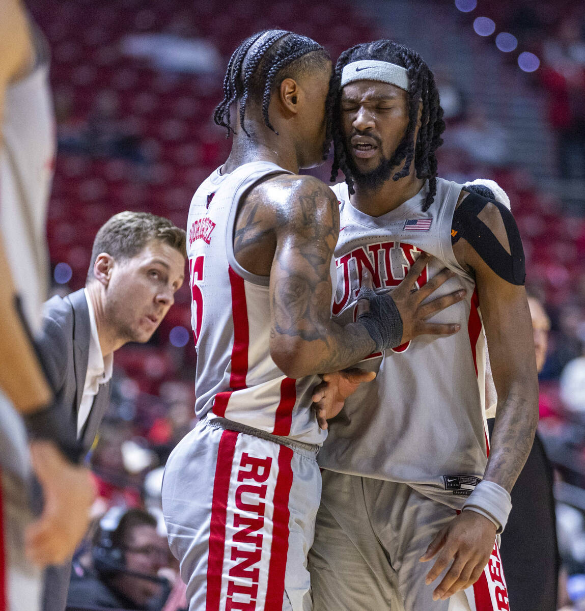 UNLV guard Luis Rodriguez (15) attempts to calm down forward Keylan Boone (20) frustrated by th ...