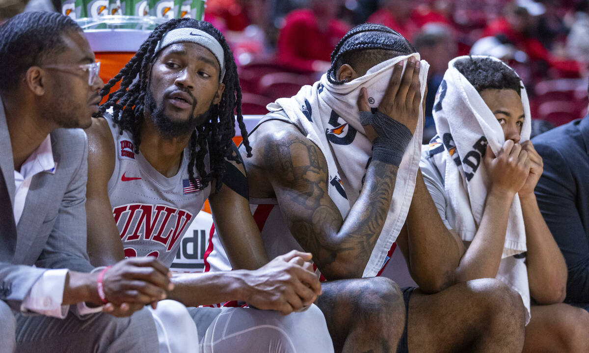 UNLV forward Keylan Boone (20), guard Luis Rodriguez (15) and guard Dedan Thomas Jr. (11) are d ...