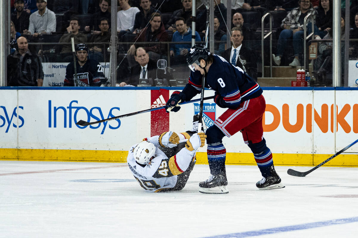 Vegas Golden Knights center Ivan Barbashev (49) falls after being checked by New York Rangers d ...