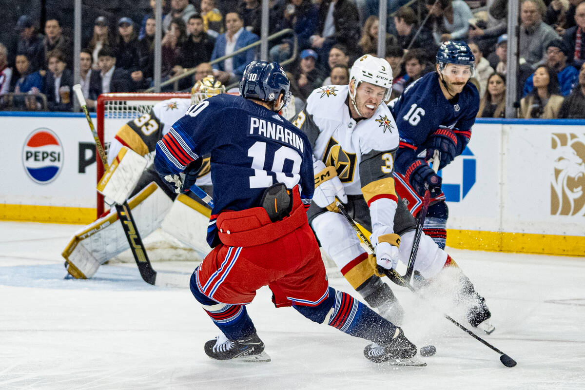 Vegas Golden Knights center Ivan Barbashev (49) falls after being checked by New York Rangers d ...