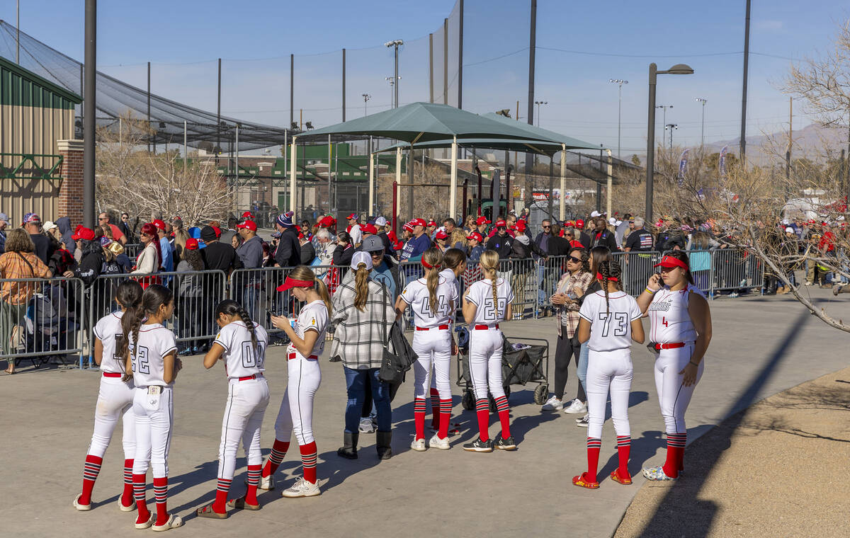 Softball players look on as supporters line up inside to see Republican presidential candidate ...