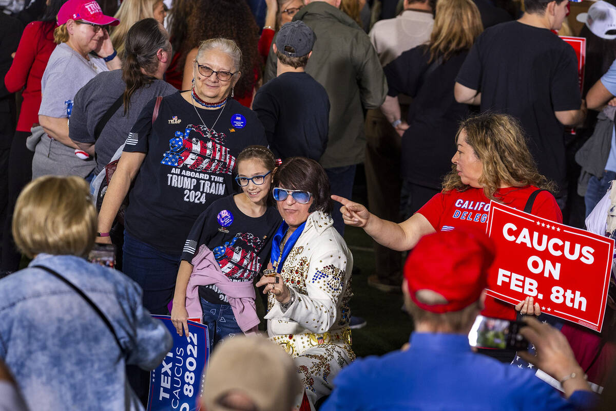 Supporters gather for an photo with Elvis as Republican presidential candidate former President ...
